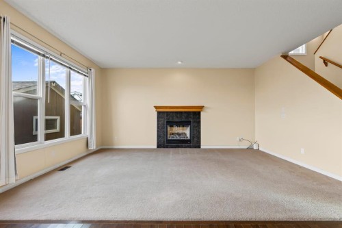 1043 Copperfield Boulevard Se, Calgary, AB - Indoor Photo Showing Living Room With Fireplace