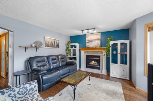 168 Fairways Drive Nw, Airdrie, AB - Indoor Photo Showing Living Room With Fireplace