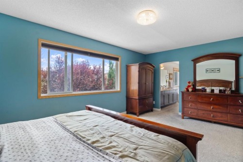168 Fairways Drive Nw, Airdrie, AB - Indoor Photo Showing Bedroom