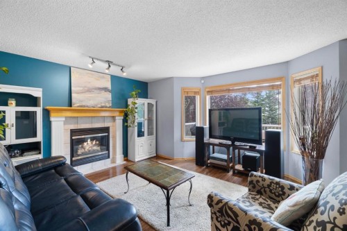 168 Fairways Drive Nw, Airdrie, AB - Indoor Photo Showing Living Room With Fireplace