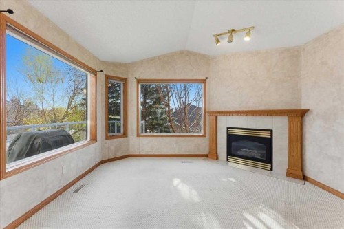 69 Scimitar Point Nw, Calgary, AB - Indoor Photo Showing Living Room With Fireplace