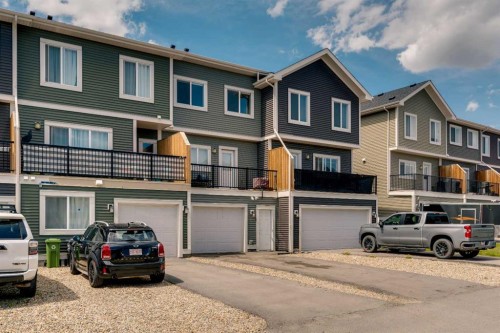 140 Sundown Road, Cochrane, AB - Outdoor With Balcony With Facade