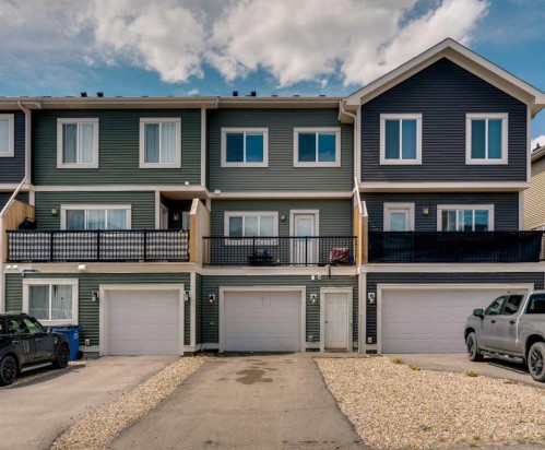 140 Sundown Road, Cochrane, AB - Outdoor With Balcony With Facade