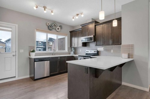 140 Sundown Road, Cochrane, AB - Indoor Photo Showing Kitchen With Upgraded Kitchen