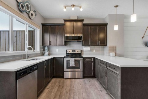 140 Sundown Road, Cochrane, AB - Indoor Photo Showing Kitchen With Double Sink With Upgraded Kitchen