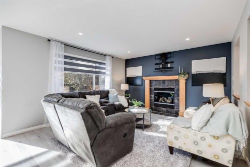 208 Fairways Bay Nw, Airdrie, AB - Indoor Photo Showing Living Room With Fireplace