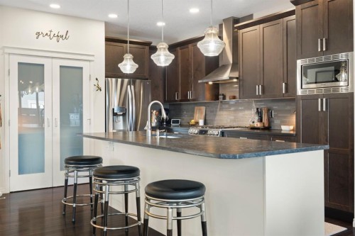 92 Thoroughbred Boulevard, Cochrane, AB - Indoor Photo Showing Kitchen With Upgraded Kitchen
