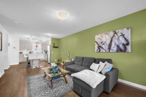 504-1225 Kings Heights Way Se, Airdrie, AB - Indoor Photo Showing Living Room