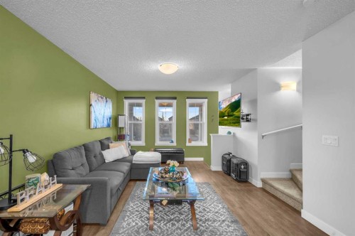 504-1225 Kings Heights Way Se, Airdrie, AB - Indoor Photo Showing Living Room