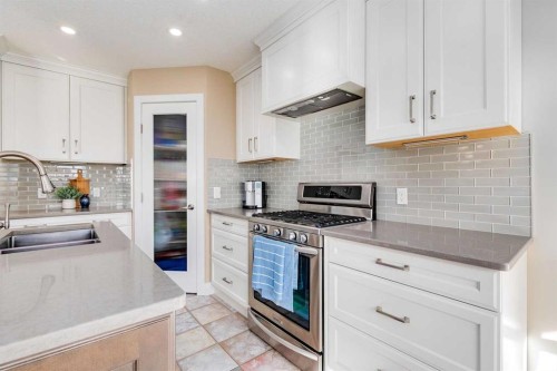 1719 Woodside Boulevard Nw, Airdrie, AB - Indoor Photo Showing Kitchen With Double Sink With Upgraded Kitchen