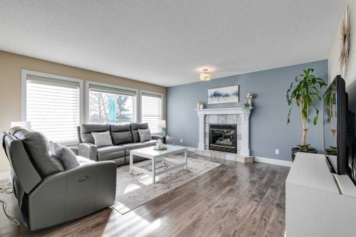 1719 Woodside Boulevard Nw, Airdrie, AB - Indoor Photo Showing Living Room With Fireplace