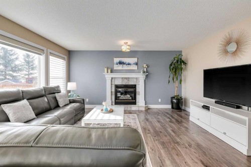 1719 Woodside Boulevard Nw, Airdrie, AB - Indoor Photo Showing Living Room With Fireplace