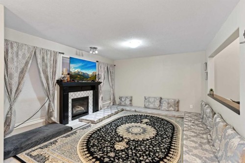 67 Anaheim Crescent Ne, Calgary, AB - Indoor Photo Showing Other Room With Fireplace