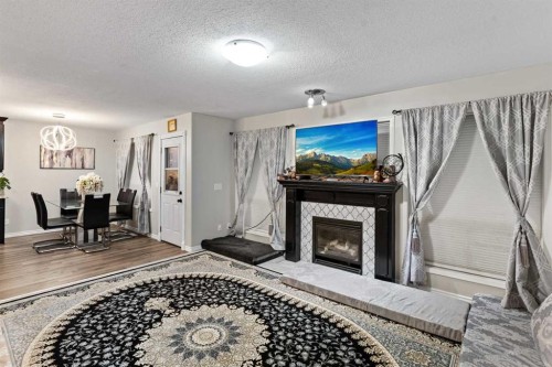 67 Anaheim Crescent Ne, Calgary, AB - Indoor Photo Showing Living Room With Fireplace