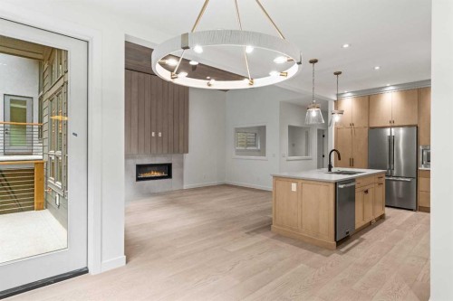 249B Three Sisters Drive, Canmore, AB - Indoor Photo Showing Kitchen With Fireplace