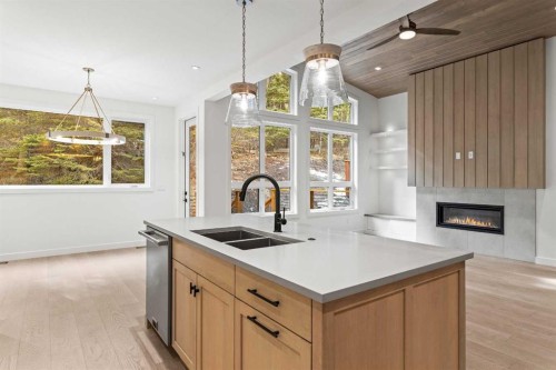249B Three Sisters Drive, Canmore, AB - Indoor Photo Showing Kitchen With Fireplace With Double Sink