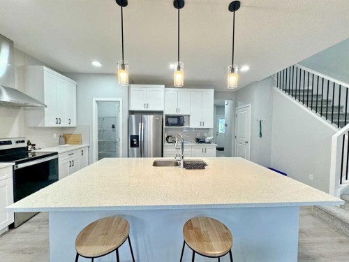 14 Sundown Close, Cochrane, AB - Indoor Photo Showing Kitchen With Stainless Steel Kitchen With Upgraded Kitchen