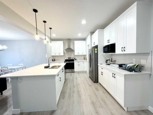 14 Sundown Close, Cochrane, AB - Indoor Photo Showing Kitchen With Double Sink With Upgraded Kitchen