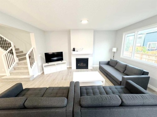 14 Sundown Close, Cochrane, AB - Indoor Photo Showing Living Room With Fireplace