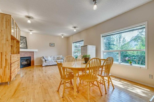 214 Springmere Close, Chestermere, AB - Indoor Photo Showing Dining Room With Fireplace