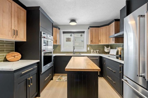22 Hunters Gate, Okotoks, AB - Indoor Photo Showing Kitchen With Double Sink