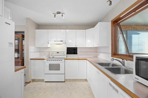 220 Sunset Place, Okotoks, AB - Indoor Photo Showing Kitchen With Double Sink
