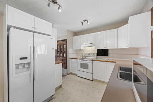 220 Sunset Place, Okotoks, AB - Indoor Photo Showing Kitchen With Double Sink