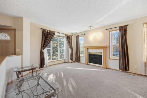 220 Sunset Place, Okotoks, AB - Indoor Photo Showing Other Room With Fireplace