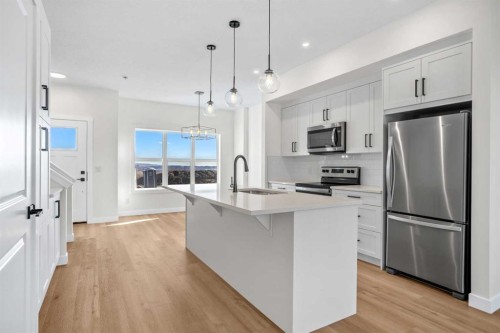 804-525 River Heights Drive, Cochrane, AB - Indoor Photo Showing Kitchen With Stainless Steel Kitchen With Upgraded Kitchen