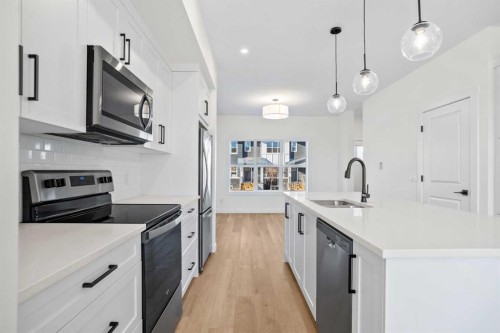 804-525 River Heights Drive, Cochrane, AB - Indoor Photo Showing Kitchen With Stainless Steel Kitchen With Upgraded Kitchen
