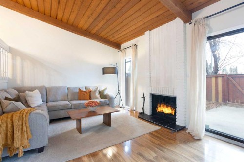 54-10030 Oakmoor Way Sw, Calgary, AB - Indoor Photo Showing Living Room With Fireplace