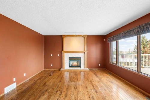 201 Signature Way Sw, Calgary, AB - Indoor Photo Showing Living Room With Fireplace