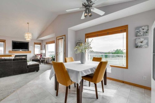 133 Chaparral Ridge Point Se, Calgary, AB - Indoor Photo Showing Dining Room With Fireplace