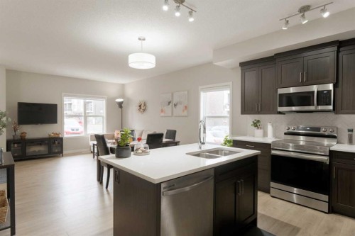 701-250 Fireside View, Cochrane, AB - Indoor Photo Showing Kitchen With Double Sink