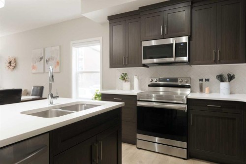 701-250 Fireside View, Cochrane, AB - Indoor Photo Showing Kitchen With Double Sink