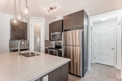 1213-2461 Baysprings Link Sw, Airdrie, AB - Indoor Photo Showing Kitchen With Stainless Steel Kitchen With Double Sink With Upgraded Kitchen