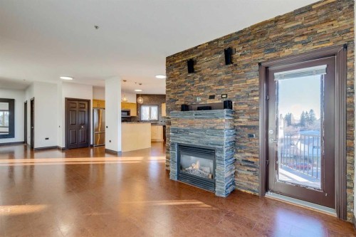 403-3810 43 Street Sw, Calgary, AB - Indoor Photo Showing Living Room With Fireplace