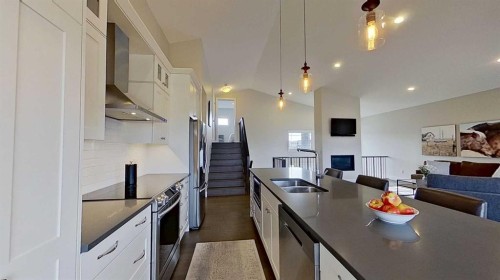 130 Riverwood Crescent Sw, Diamond Valley, AB - Indoor Photo Showing Kitchen With Stainless Steel Kitchen With Double Sink With Upgraded Kitchen