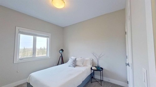 130 Riverwood Crescent Sw, Diamond Valley, AB - Indoor Photo Showing Bedroom