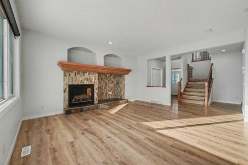 134 Autumn Gardens Se, Calgary, AB - Indoor Photo Showing Living Room With Fireplace