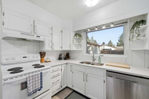 67 Lake Sylvan Close Se, Calgary, AB - Indoor Photo Showing Kitchen With Double Sink