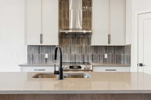 120 Quartz Crescent, Cochrane, AB - Indoor Photo Showing Kitchen With Double Sink With Upgraded Kitchen