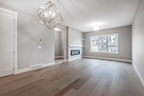 925 Reynolds Lane Sw, Airdrie, AB - Indoor Photo Showing Other Room With Fireplace