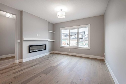 925 Reynolds Lane Sw, Airdrie, AB - Indoor Photo Showing Other Room With Fireplace