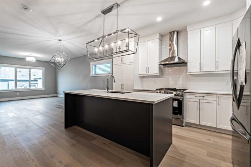 925 Reynolds Lane Sw, Airdrie, AB - Indoor Photo Showing Kitchen With Upgraded Kitchen