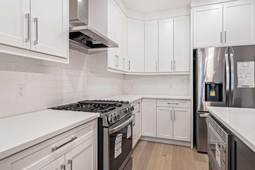 925 Reynolds Lane Sw, Airdrie, AB - Indoor Photo Showing Kitchen With Upgraded Kitchen
