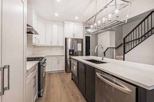 925 Reynolds Lane Sw, Airdrie, AB - Indoor Photo Showing Kitchen With Double Sink With Upgraded Kitchen