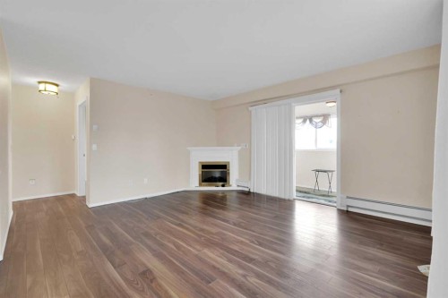 346-165 Manora Place Ne, Calgary, AB - Indoor Photo Showing Living Room With Fireplace