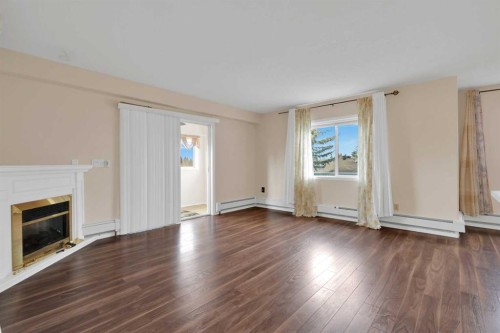 346-165 Manora Place Ne, Calgary, AB - Indoor Photo Showing Living Room With Fireplace