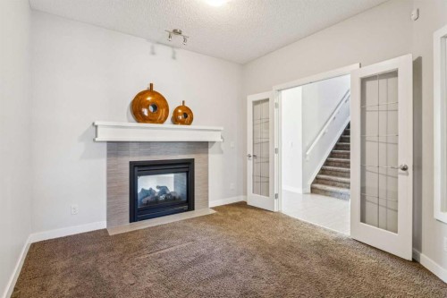 15 Sherwood Gate Nw, Calgary, AB - Indoor Photo Showing Living Room With Fireplace